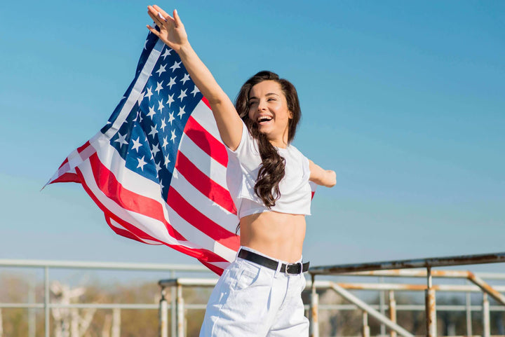 Girl happily holding the American flag